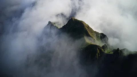 Awesome timelapse. White clouds flows above green peak edge. Aerial panorama Stock Footage 169091521
