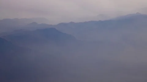 Awesome view on mountains in the cloud veil through the aircraft window. 4K Vidéo 70361016
