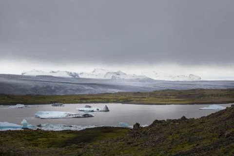 Awesome view over the glacier with a lot of ice rocks in the lake in front... Stock Photos