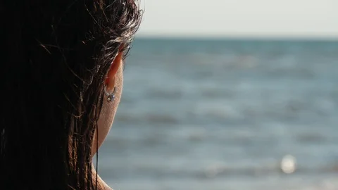 Awesome young cute lady looking on the sea waves in slow motion, Close up Видео 112746895