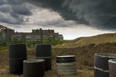 Awful thunderclouds over a poor sleeping district and construction site Stock-Fotos