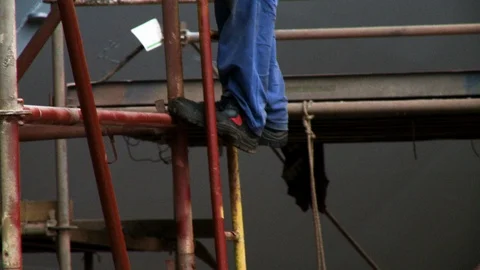 Awkward accident prone feet climbing down dangerous scaffolding 스톡 동영상 123727904