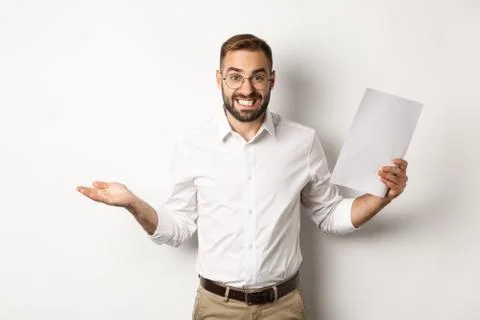 Awkward manager showing document and shrugging, looking guilty of mistake Stock Photos