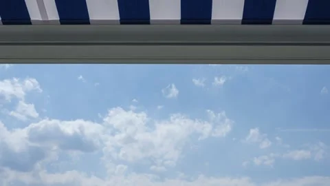 Awning on balcony with clouds in the blue sky time lapse Stock Footage 136949003
