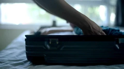 Awoman puts things in a suitcase. Preparation for a trip or journey. packing Stock-Footage 336237607