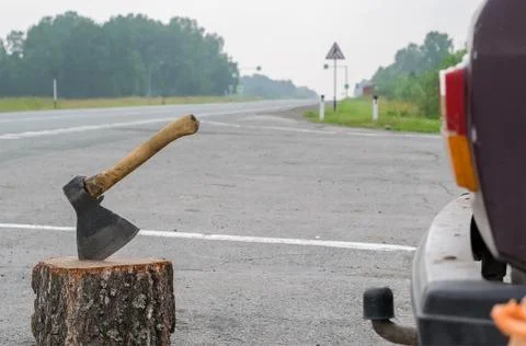 Ax on the background of the road Stock Photos