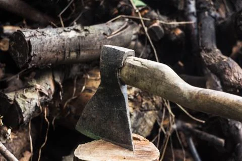 An ax in a hemp on logs background Stock Photos