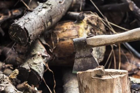 An ax in a hemp on logs background Stock Photos