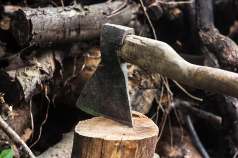 An ax in a hemp on logs background Stock Photos
