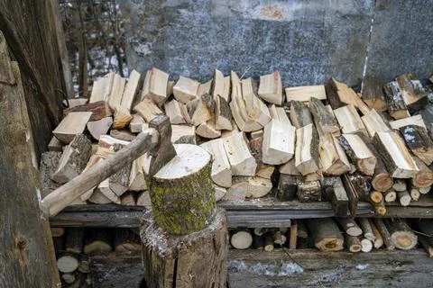 Ax stuck in a log. A pine log cut in half. Preparation of firewood. Stock Photos