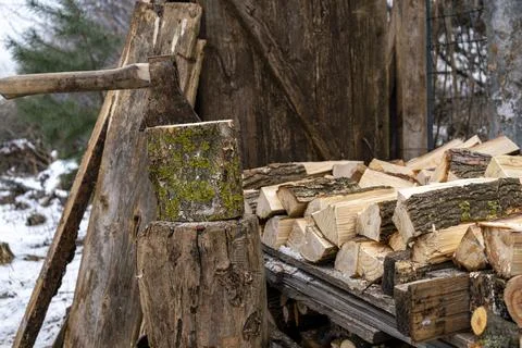 Ax stuck in a log. A pine log cut in half. Preparation of firewood. Stock Photos