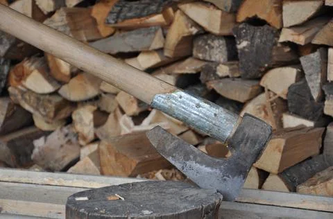 An ax stuck in a tree stump Stock Photos
