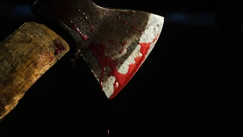 Axe with blood in hand on the dark background. Close-up shot Stock Footage 105246143