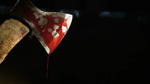 Axe with blood in hand on the dark background Stock Footage 105246945