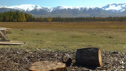Axe in a log, closeup.scenic mountain landscape 스톡 동영상 101275347