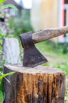 An axe in a log in the open air. Cooking for chopping wood. Stock Photos