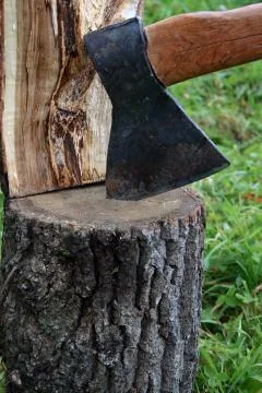 Axe in log Stock Photos