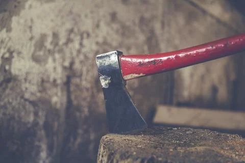 An axe in a log Stock Photos