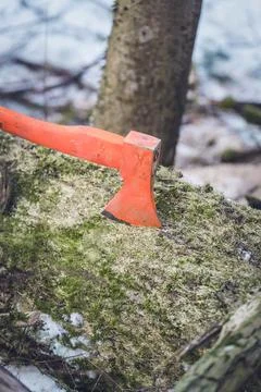 An axe in a log Stock Photos