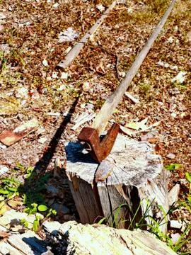 Axe stuck in wood Stock Photos