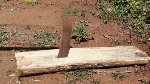 Axe is used to split the wood into pieces a scene from rural area Stock Footage 332862327
