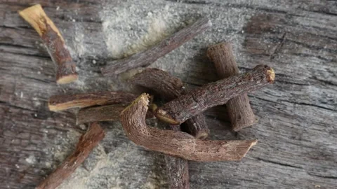 Ayurvedic mulethi or liquorice root stick or jeshthamadh powder on wooden b.. Stockbeeldmateriaal 334306833