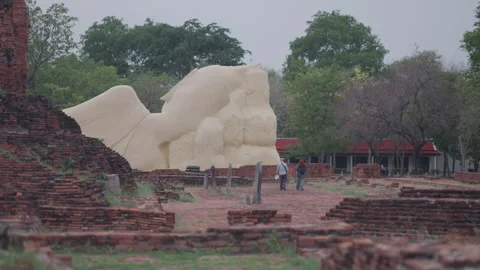 Ayutthaya Reclining Buddha Back View with Walking Tourists Stock Footage 337532704