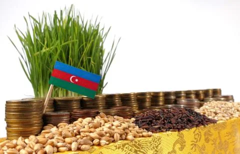 Azerbaijan flag waving with stack of money coins and piles of wheat and ric.. Stock Photos