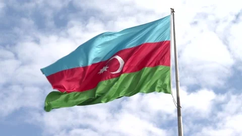 Azerbaijani Three Colored State flag waving in the Cloudy Blue Sky Stock Footage 236612980