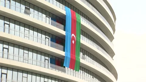 Azerbaijani Three Colored State flag Hanging over Different buildings Stock Footage 239329908