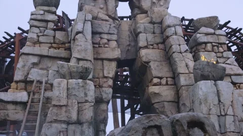 Aztec Temple Theme Rollercoaster, Flames and Ancient Gods in Stone, Tilt Reveal Video stock 342893961