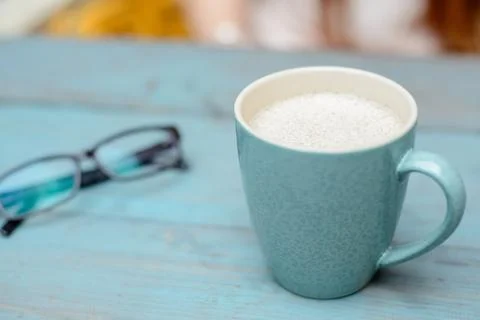Azure cup of coffee on table Stock Photos