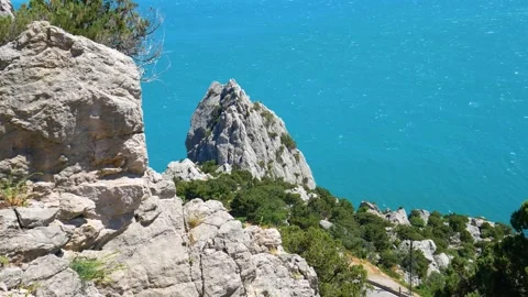 The azure sea against the backdrop of mountains and green trees Stock Footage 245244982