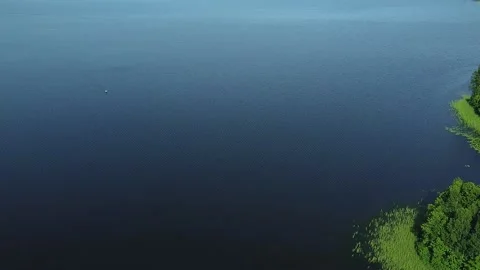 Azure surface of the lake is a reflection of the sky 스톡 동영상 138233486