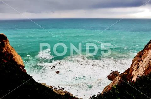 Azure water against the background of rocks, flying eagle Stock Photos