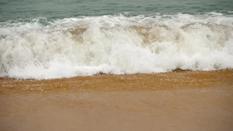 Azure wave rolls over the sandy shore Stock Footage 157231606