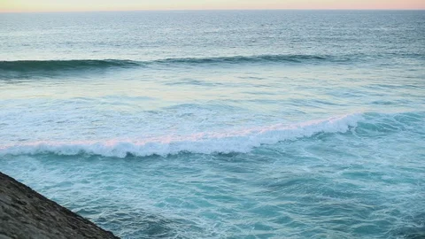 Azure wave rolls on the rocks of the ocean Stock Footage 130022426