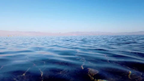 Azure waves of the bay and pebbles under water Stock Footage 146023503