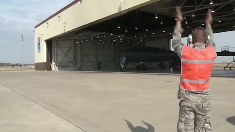B-2 Stealth bomber directed out of hangar Stock Footage 109576261