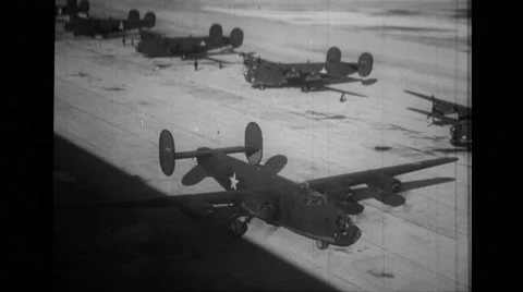 B-24 Liberator taxiing on runway beside hangar Stock Footage