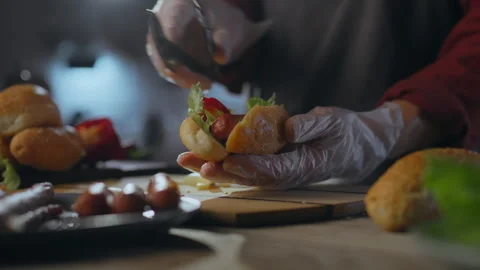 B-B-Q. A talented pastry chef dressed in an apron folds a sausage into a bre Stock Footage 272149401