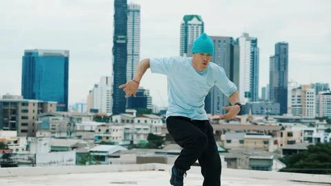 B-boy dancer practicing street dancing at rooftop with city view. Endeavor. 写真素材