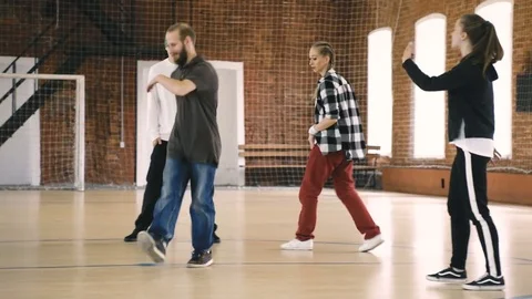 B-boy dances in front of her friends Stock Footage 79154510