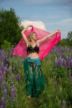 B dancer performing in a vibrant lavender field under a blue sky Stock Photos