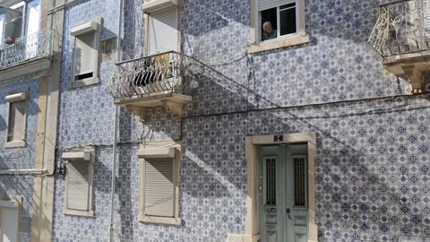 B-roll atmosphere shot of a local elderly lady peeking out of her window Stock Footage 85739344