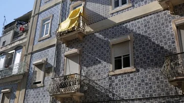 B-roll atmosphere shot of sheet flapping from a tile building in Lisbon Stock Footage 85739281