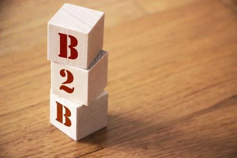 B2B business to business concept. Stack of wooden cubes on wooden floor Stockfoto's
