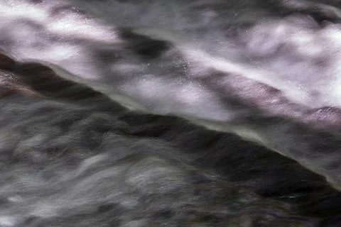 The babbling brook flows over the rocks Stock Photos