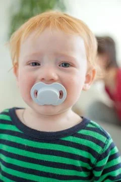Babe with a pacifier Stock Photos