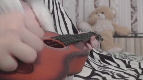 Babe Plays Guitar With His Hands, and Behind the Teddy Bear Stock Footage 72617465